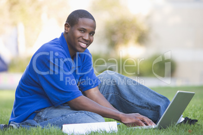 University student using laptop outside