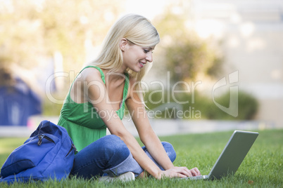 University student using laptop outside