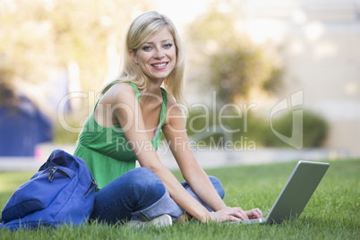 University student using laptop outside