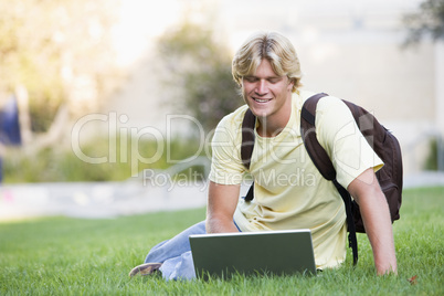 University student using laptop outside