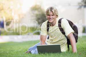 University student using laptop outside