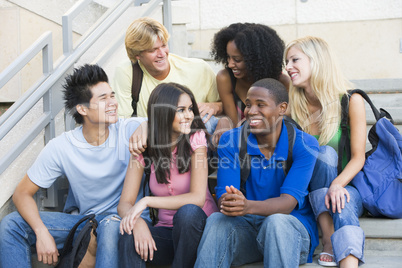 Group of university students sitting on steps