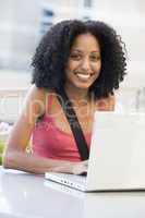Female student using laptop outside
