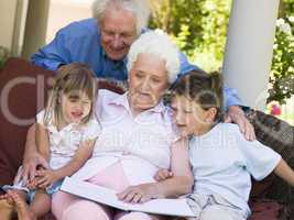 Grandparents reading to grandchildren