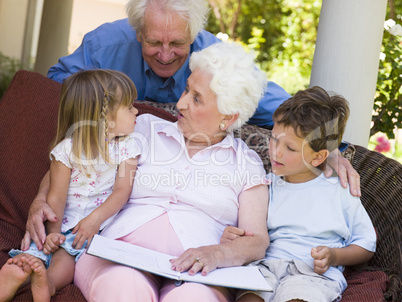 Grandparents reading to grandchildren