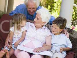 Grandparents reading to grandchildren