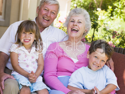 Grandparents laughing with grandchildren