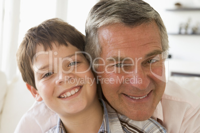 Grandfather and grandson indoors smiling