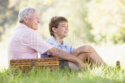 Grandfather and grandson at a picnic smiling