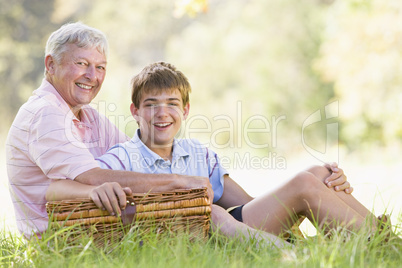 Grandfather and grandson at a picnic smiling