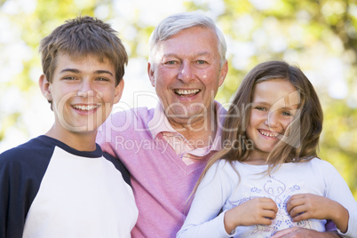 Grandfather laughing with grandchildren