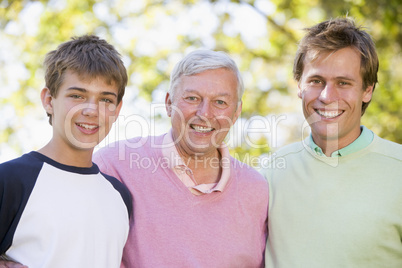 Grandfather with son and grandson smiling