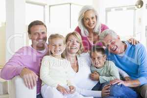 Family sitting indoors smiling
