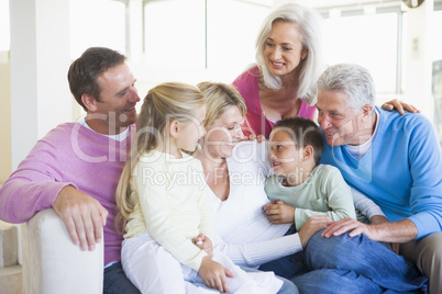 Family sitting indoors smiling