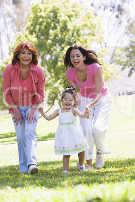 Grandmother with adult daughter and granddaughter in park