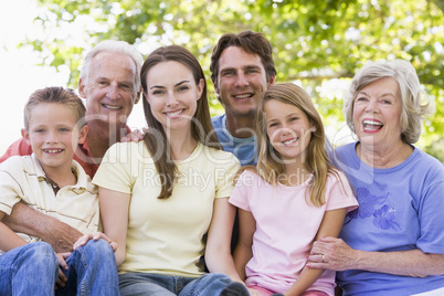 Extended family outdoors smiling