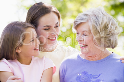 Grandmother with adult daughter and grandchild in park