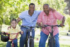 Grandfather grandson and son bike riding