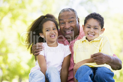 Grandfather laughing with grandchildren