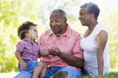 Grandparents with grandson in park