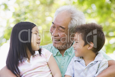 Grandfather laughing with grandchildren