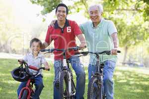 Grandfather son and grandson bike riding