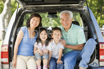 Grandparents with grandkids in tailgate of car