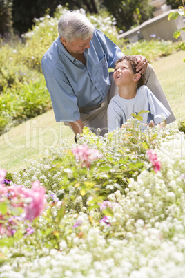 Grandfather and grandson working in the garden
