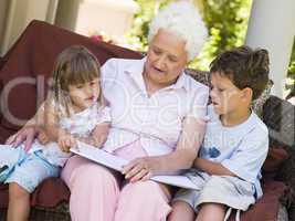 Grandmother reading to grandchildren