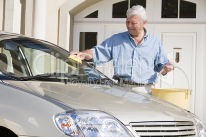 Senior man washing car