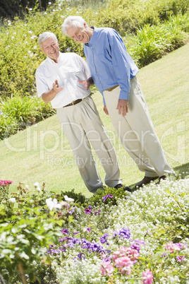 Senior men standing in garden