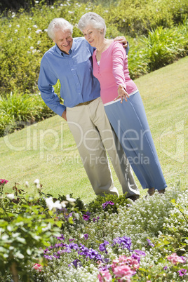 Senior couple standing in garden