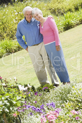 Senior couple standing in garden