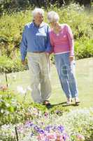 Senior couple walking in garden