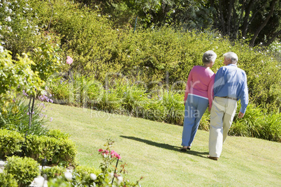 Senior couple walking in garden