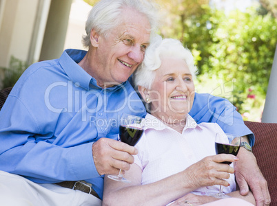Senior couple relaxing with glass of wine