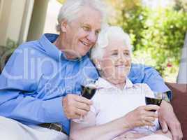 Senior couple relaxing with glass of wine