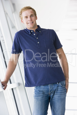 Man standing in corridor smiling