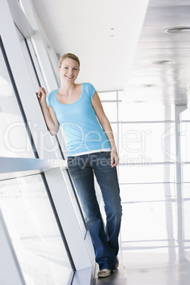 Woman standing in corridor smiling