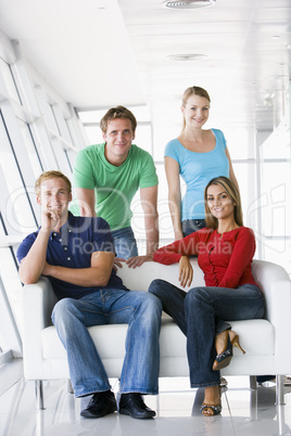 Four people in lobby smiling