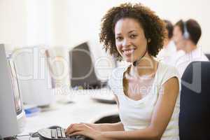Woman wearing headset in computer room smiling