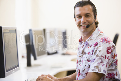 Man wearing headset in computer room smiling