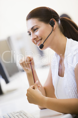 Woman wearing headset in computer room smiling