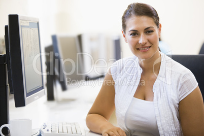 Woman sitting in computer room smiling