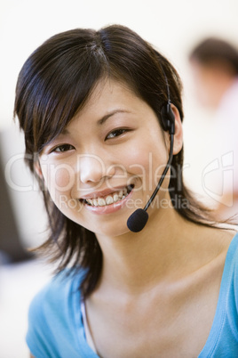 Woman wearing headset indoors smiling