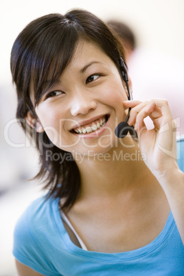 Woman wearing headset indoors smiling