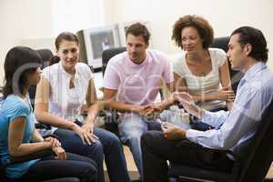 Man giving lecture to four people in computer room