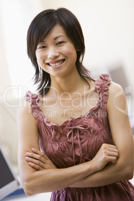 Woman standing in computer room smiling