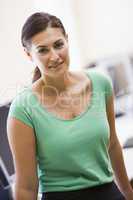 Woman standing in computer room smiling