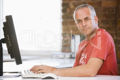 Businessman in office typing on computer